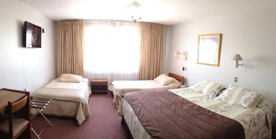 Postel nebo postele na pokoji v ubytování Hotel Quinchamali