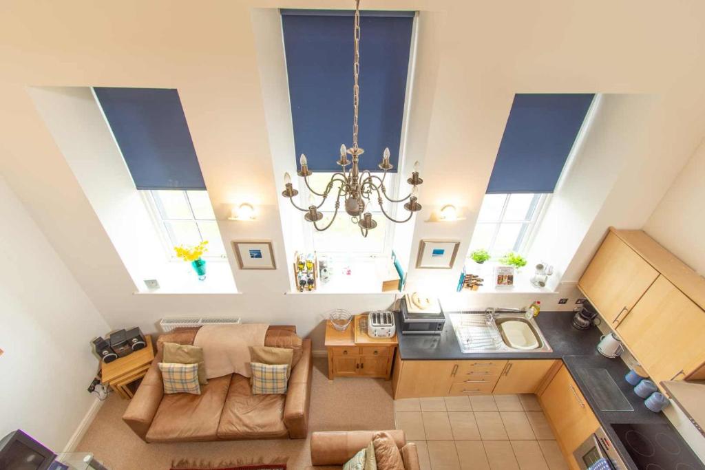 an overhead view of a living room with a chandelier at Ardnave in Port Charlotte