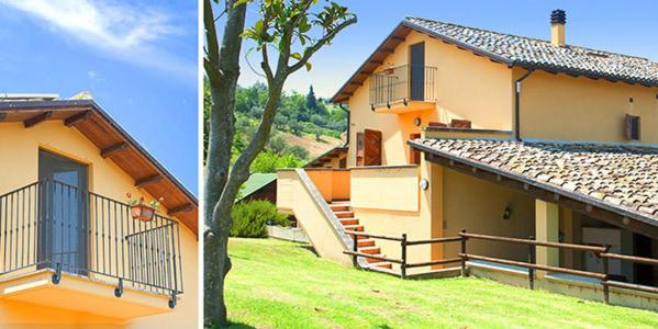a house with a balcony and a house with a tree at Antica Melegnano in Atri