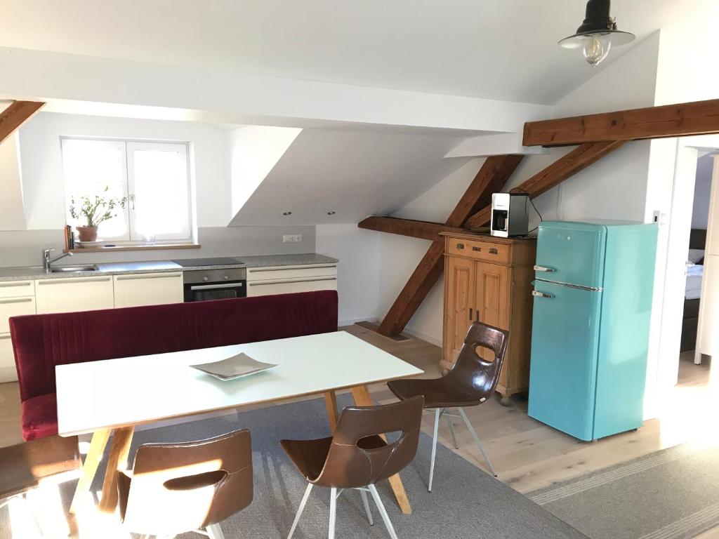 a kitchen with a white table and a blue refrigerator at Ferienwohnung Biobauernhof Peter Anderl Hof in Pfreimd