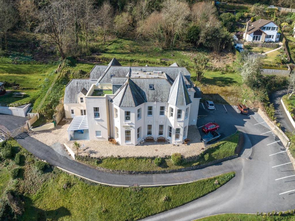 an aerial view of a large white house with a driveway at Wildercombe House in Ilfracombe