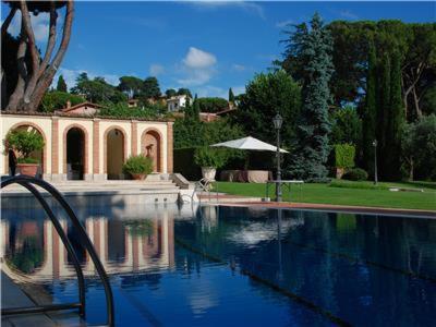 a swimming pool in a yard with a house at Villa Vesta in Grottaferrata