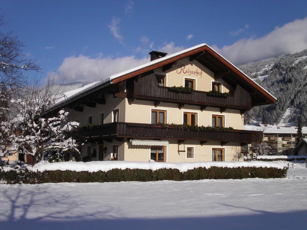 a large building with snow in front of it at Reiserhof in Zell am Ziller