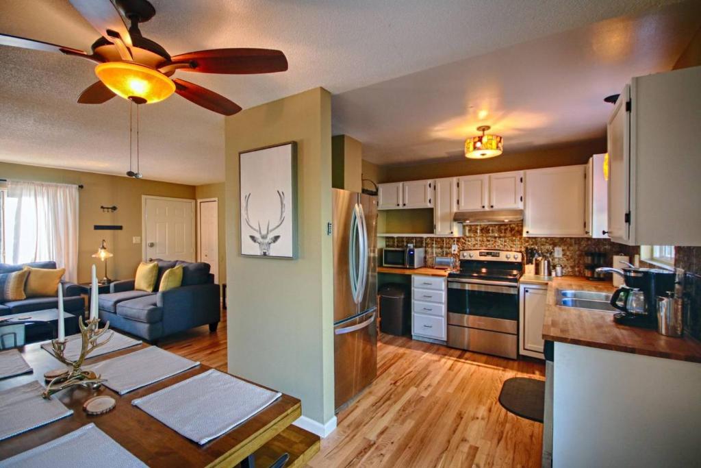 a kitchen and living room with a ceiling fan at Red Rock Canyon Retreat & Garden of the Gods- in Colorado Springs