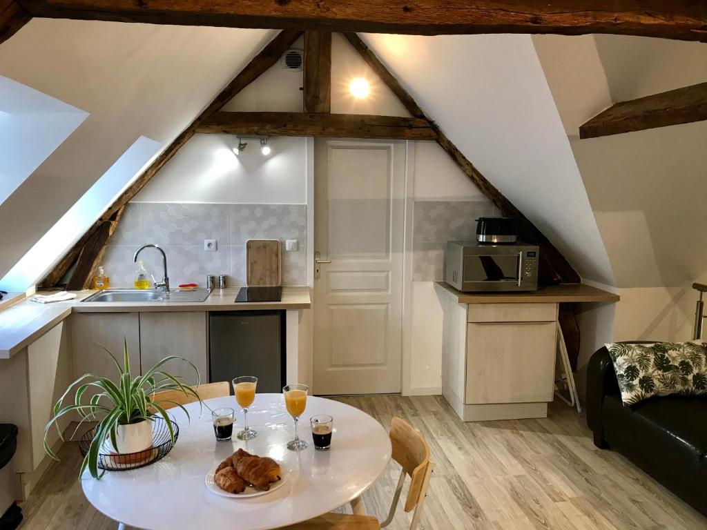 een woonkamer met een tafel en een keuken bij Résidence Le Musoir in Le Tréport