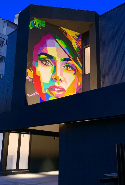 a large painting of a woman on the side of a building at The PopCity Hotel in Santiago