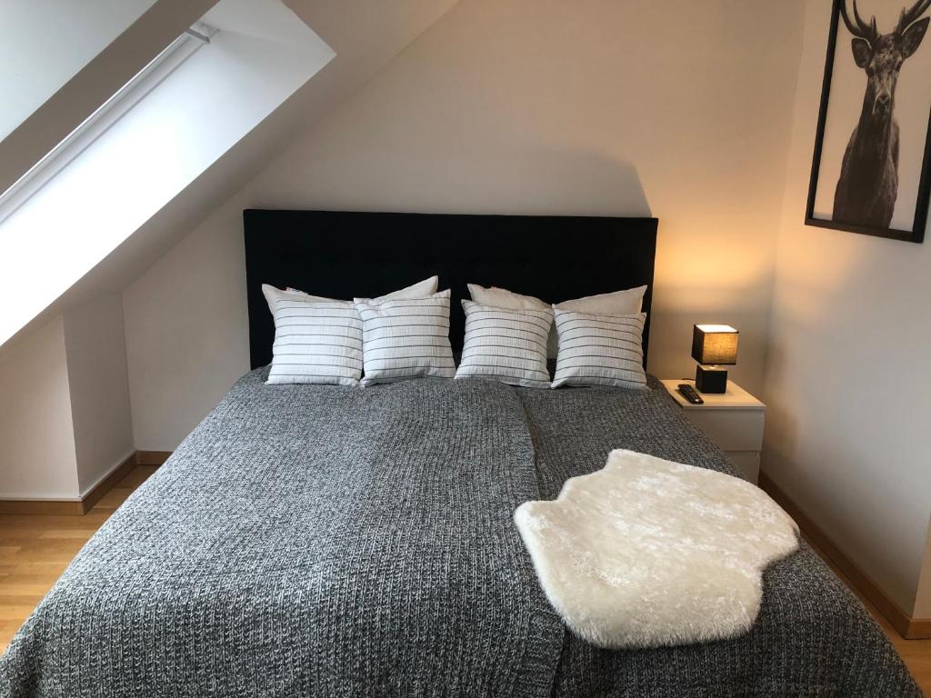 a bedroom with a large bed with white pillows at Newtown Apartments Bremen in Bremen