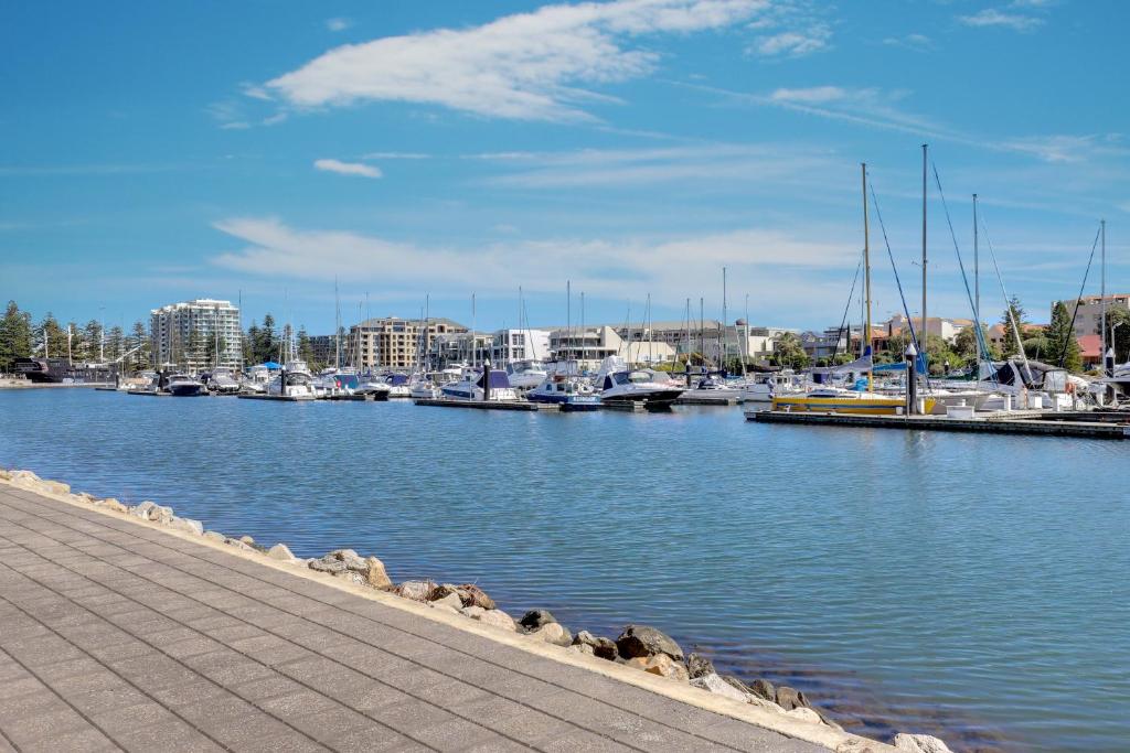 a marina with many boats in the water at Bayswaterfront Apartments in Adelaide