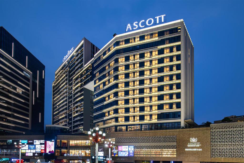 a tall building with a sign on top of it at Ascott Songshan Lake Dongguan in Dongguan