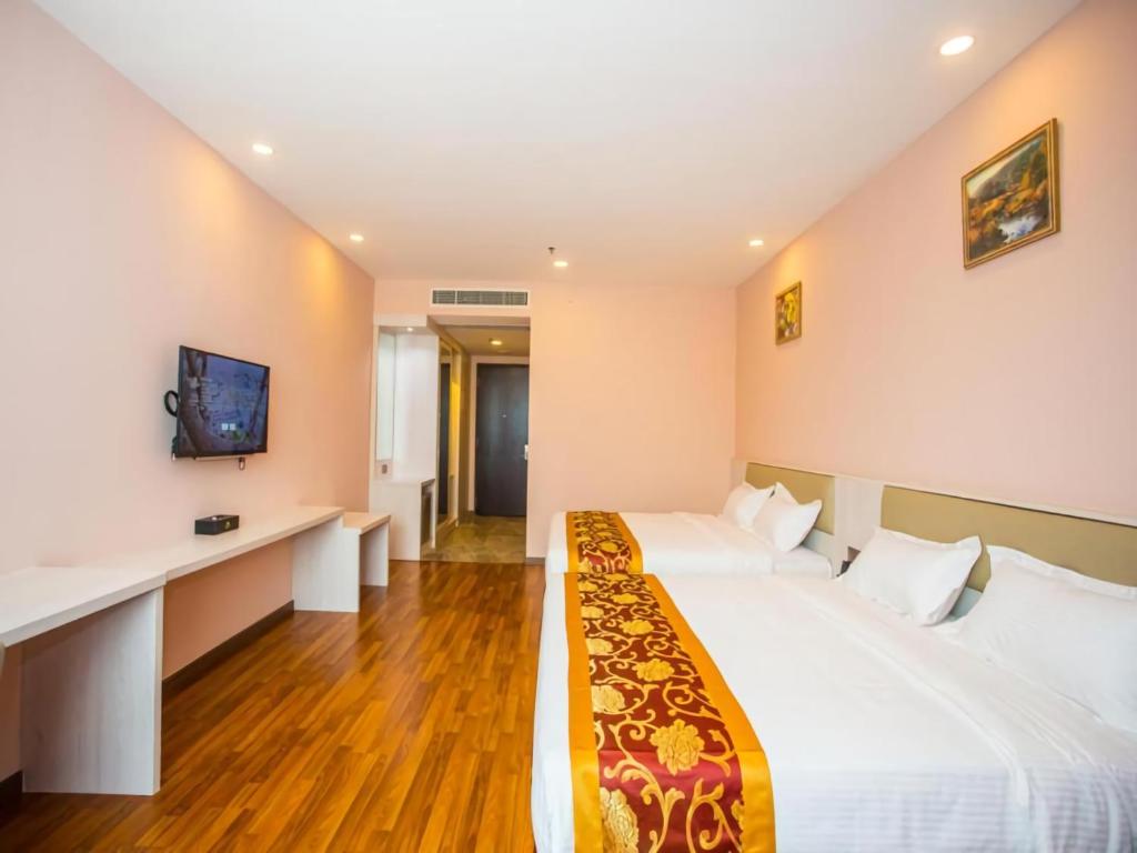 Postel nebo postele na pokoji v ubytování Austin Park Hotel