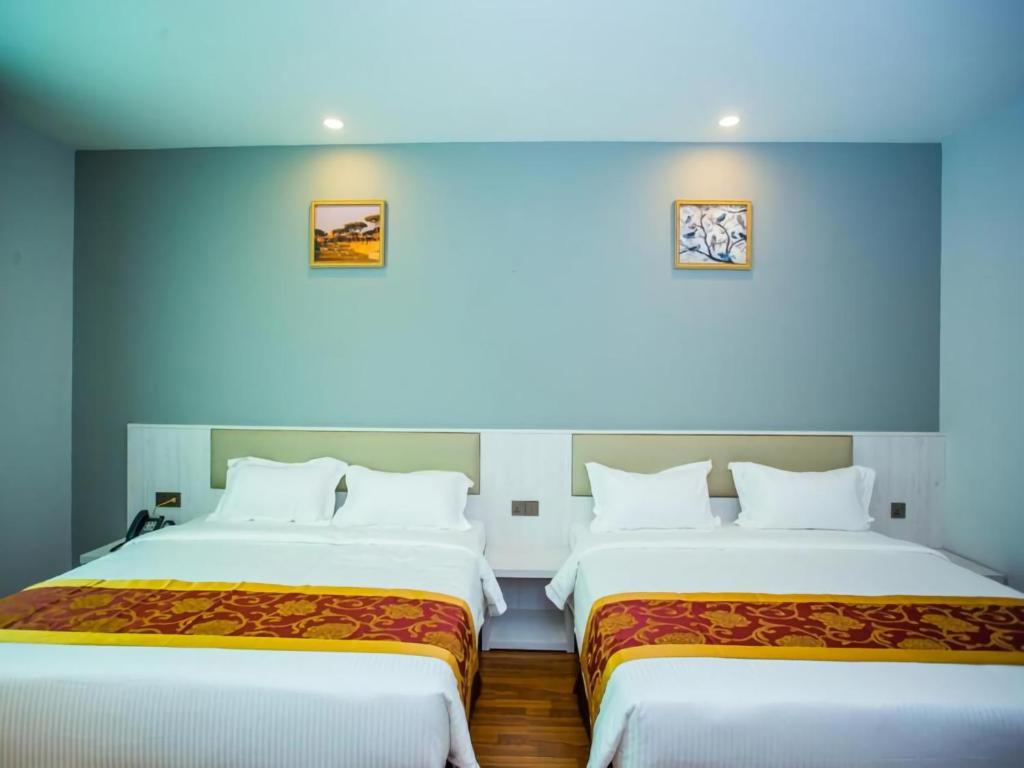 Postel nebo postele na pokoji v ubytování Austin Park Hotel