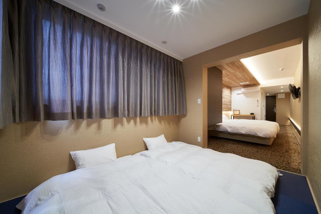 Postel nebo postele na pokoji v ubytování Carta Hotel Kyoto Bettei