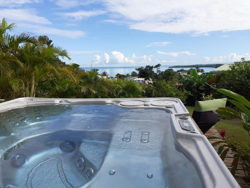 a jacuzzi tub with a view of the ocean at Bellevue Gites in Petit-Bourg