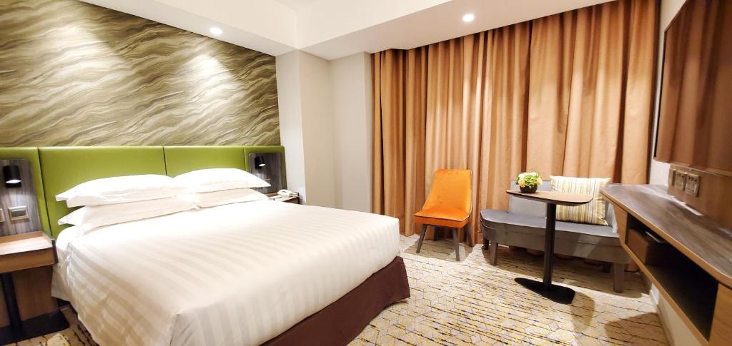 Katil atau katil-katil dalam bilik di Wharney Hotel