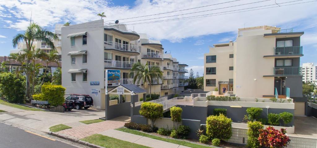 a row of buildings on a city street at Bayview Harbourview Apartments in Mooloolaba