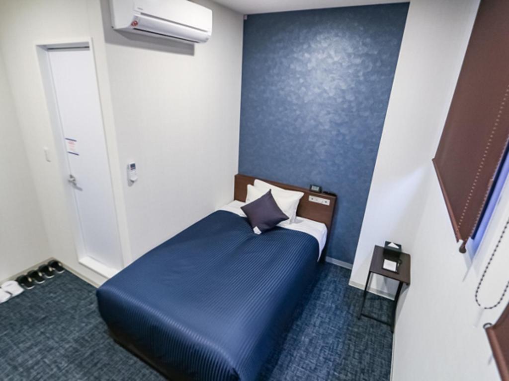Giường trong phòng chung tại HOTEL LiVEMAX BUDGET Fuji Ekimae