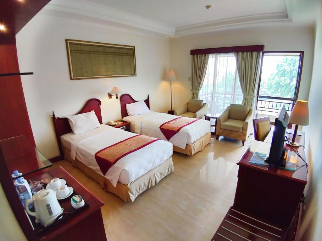 Postel nebo postele na pokoji v ubytování Le Dian Hotel
