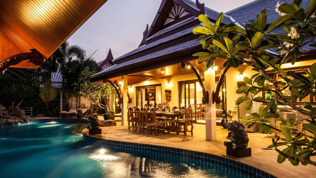 a house with a swimming pool in front of a house at Saifon Villas 3 Bedroom Pool Villa can also be rented as a 2 bedroom or 1 bedroom villa in Ao Nang Beach