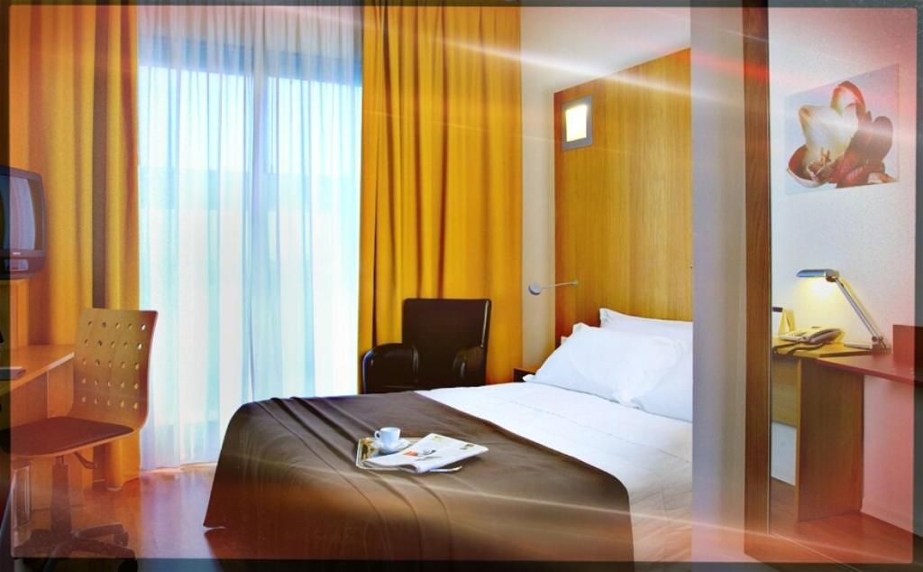 Postel nebo postele na pokoji v ubytování Executive Hotel