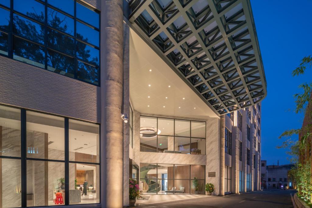 an exterior view of a building with large windows at The Luzerne Hotel in Dehua