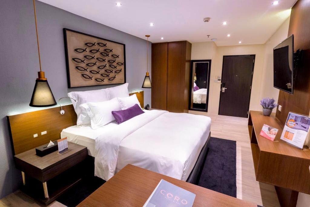 Postel nebo postele na pokoji v ubytování Coro Hotel