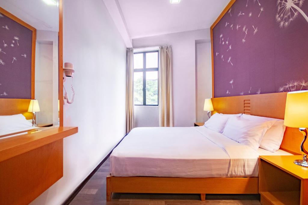 Postel nebo postele na pokoji v ubytování Nova Highlands Hotel