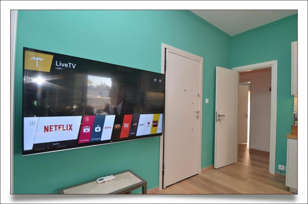 A television and/or entertainment centre at Sophia's Penthouse Apartment With Jacuzzi and Acropolis View From Big Terrace