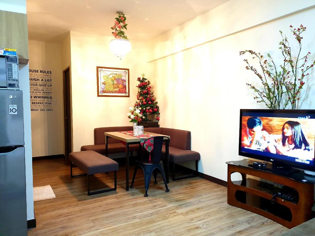 a waiting room with a table and a tv at 516 Bristle Ridge 1209 Condo Unit Rental in Baguio