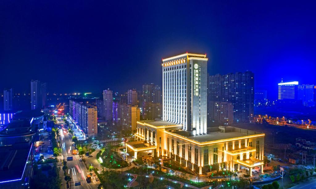 a large building in a city at night at Binhai Jinling International Hotel in Binhai