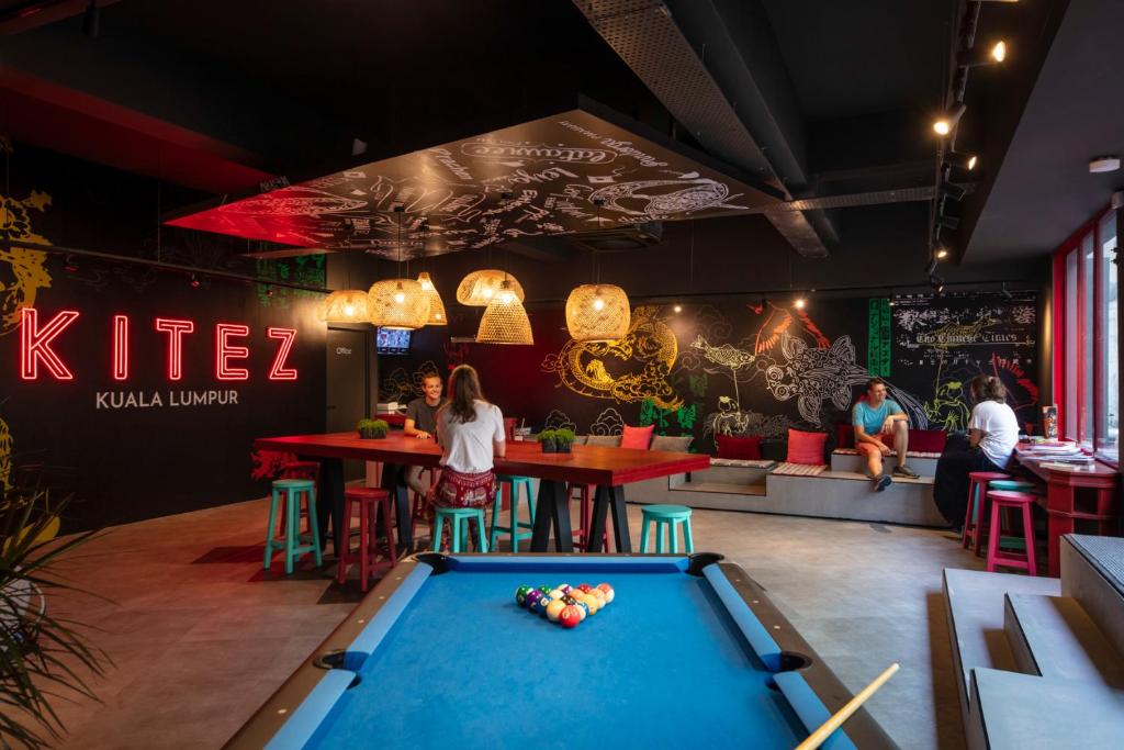 a pool table in the middle of a restaurant at Kitez Hotel & Bunkz in Kuala Lumpur
