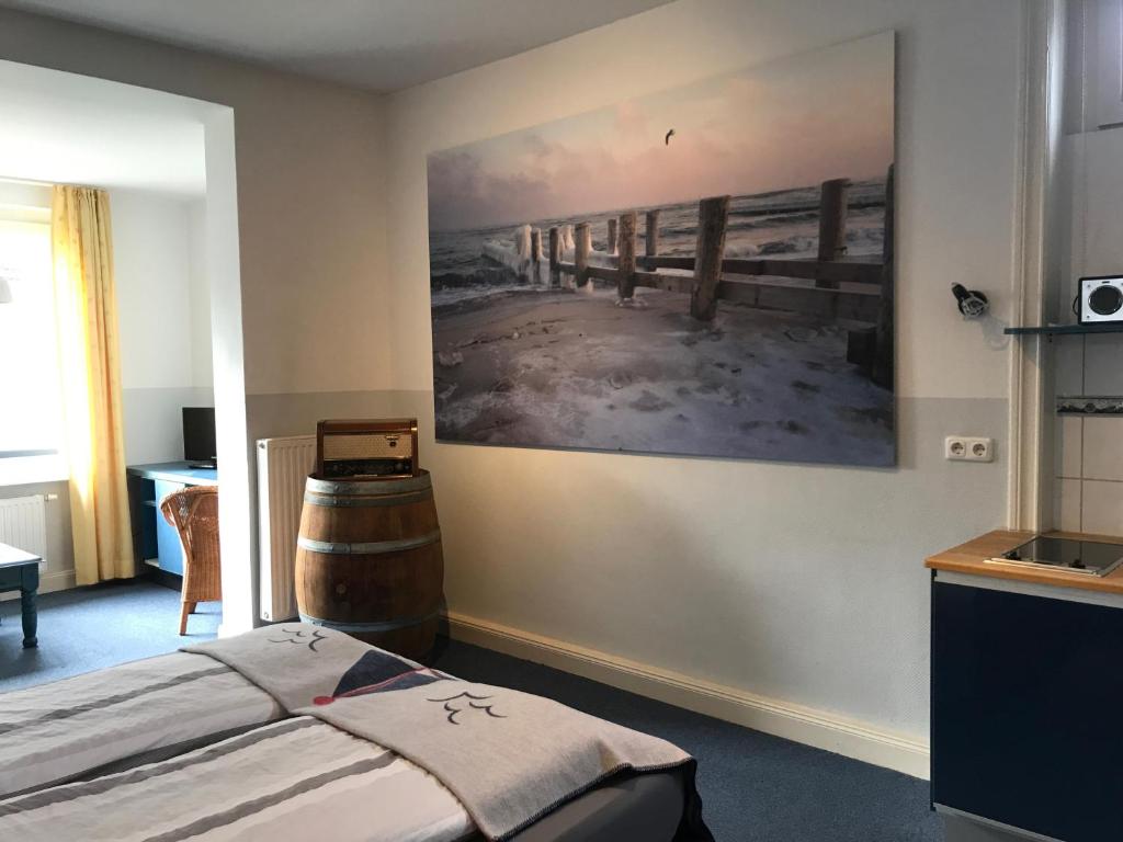 a bedroom with a bed and a painting on the wall at Villa Möwenstein in Timmendorfer Strand