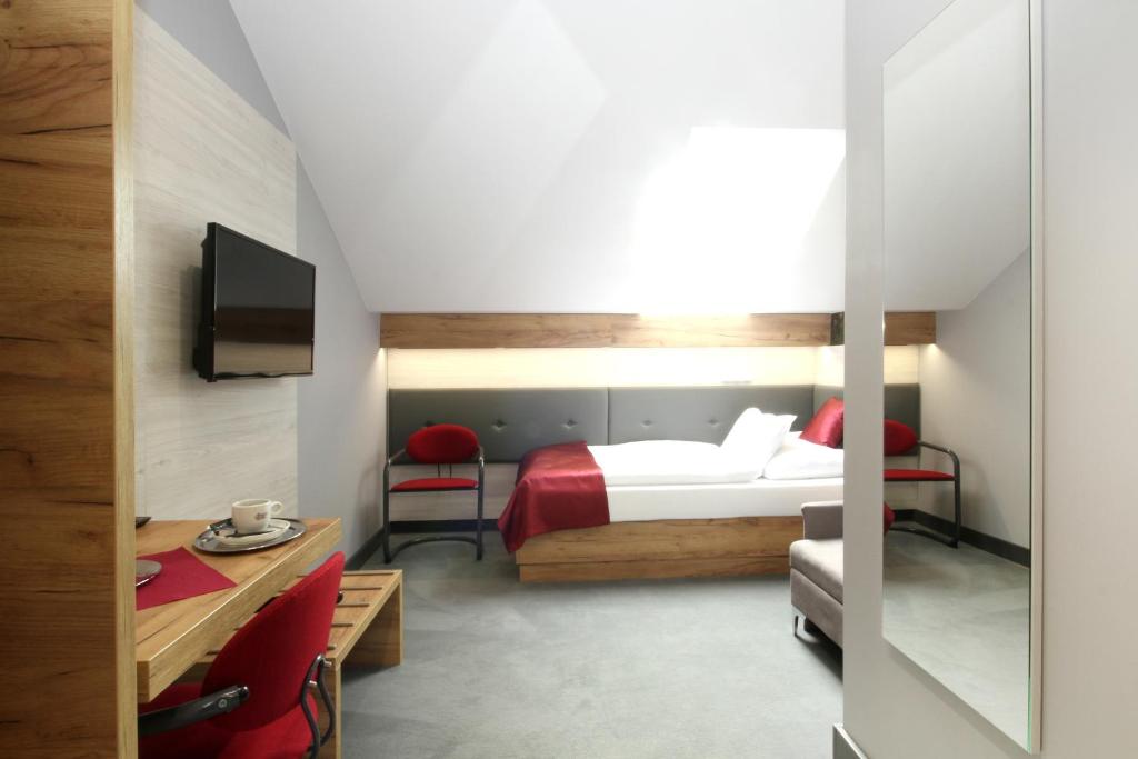 Postel nebo postele na pokoji v ubytování Hotel Strážnice