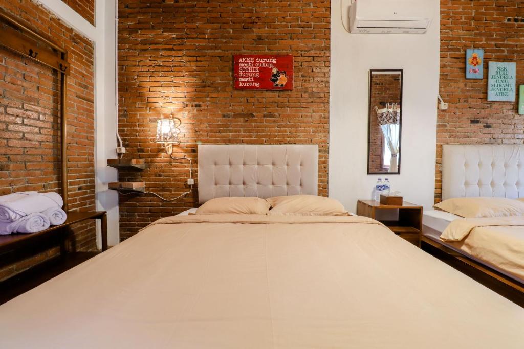 Postel nebo postele na pokoji v ubytování Omah Teras Bata Guesthouse