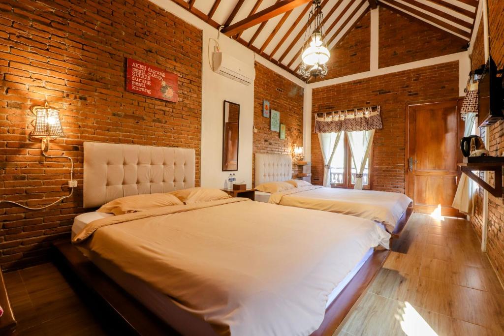 Postelja oz. postelje v sobi nastanitve Omah Teras Bata Guesthouse
