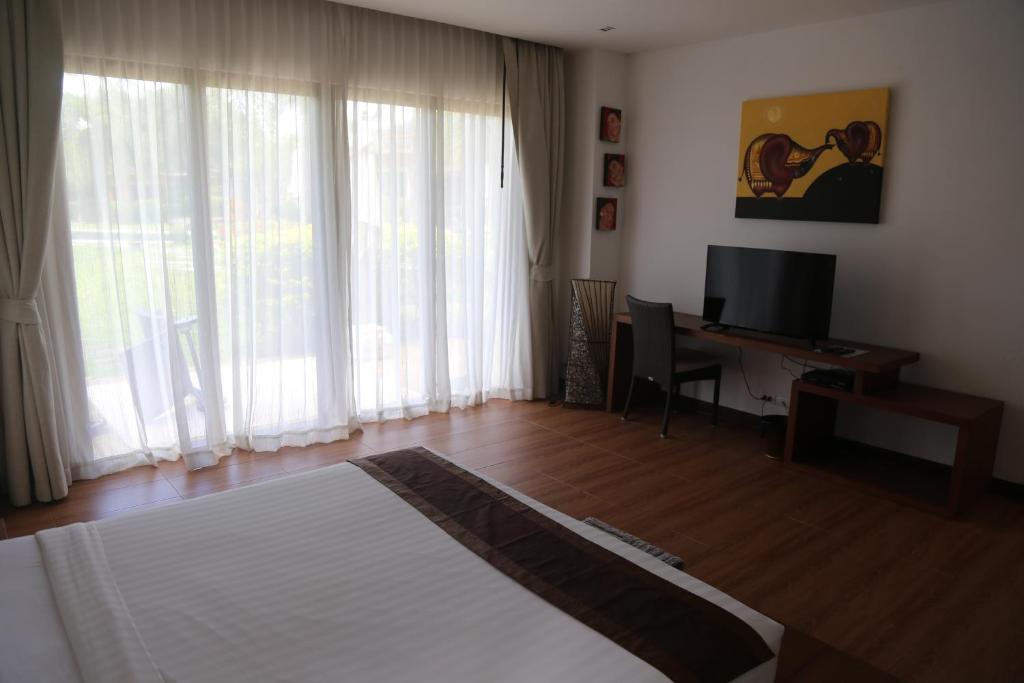 TV a/nebo společenská místnost v ubytování Laguna Villas Boutique Hotel
