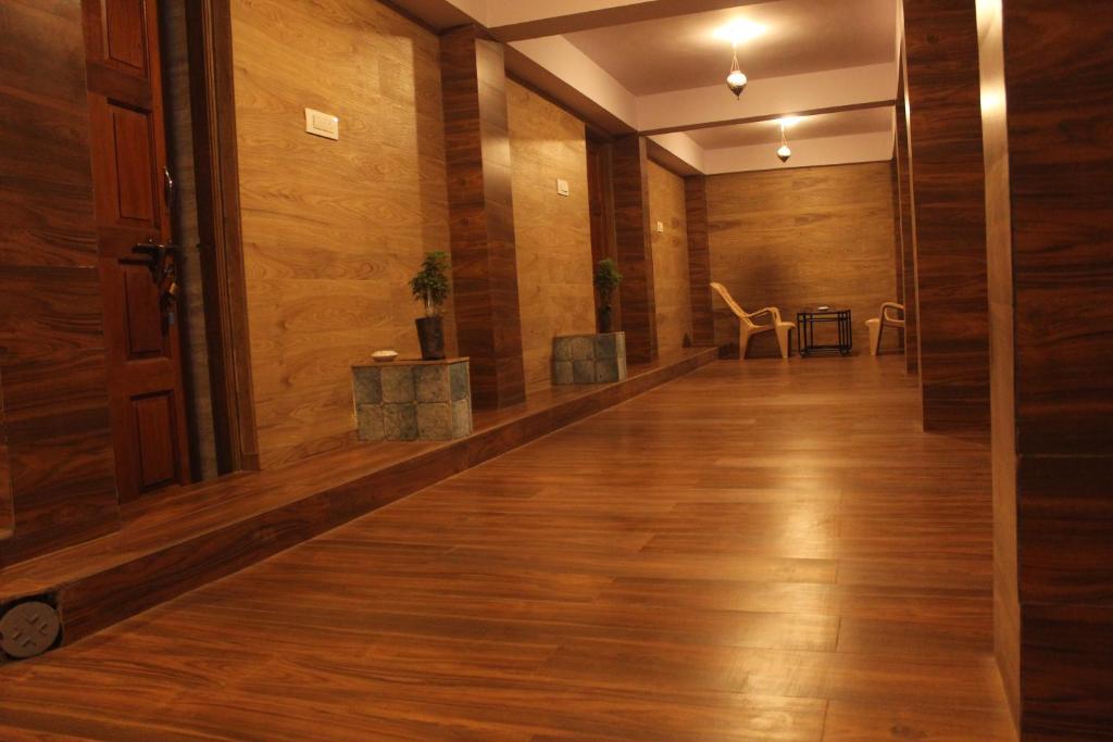 an empty hallway with wooden floors and wooden walls at The House Of Brothers in Arambol