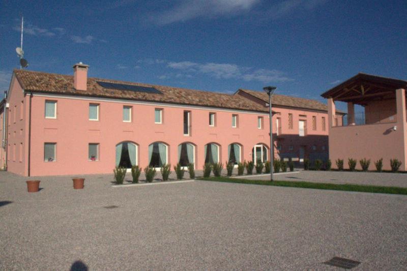 a large pink building with a lot of windows at Arneroni in Codognè