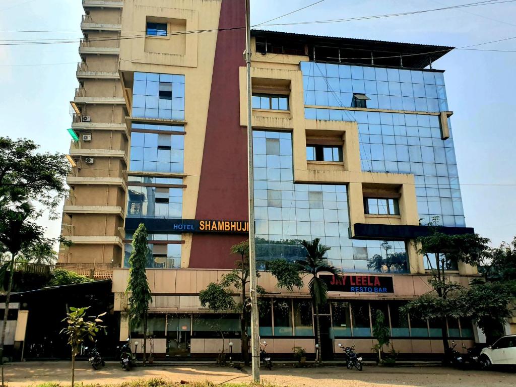 a tall building with a lot of windows at Hotel Shambuji in Thane