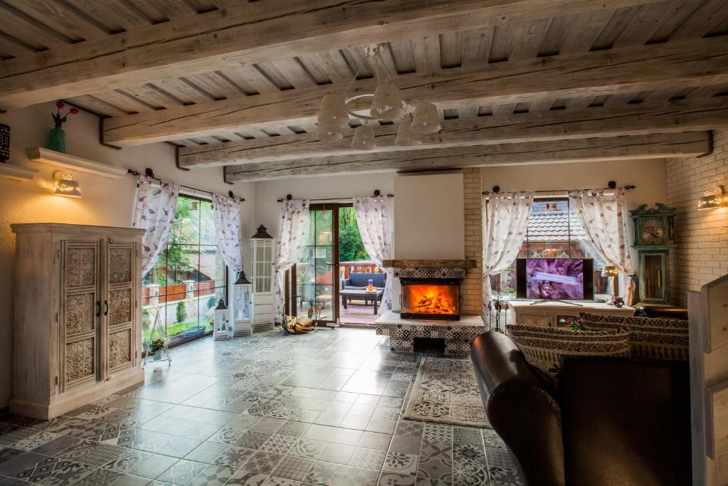 a living room with a fireplace and a couch at Chata Provence in Mýto pod Ďumbierom