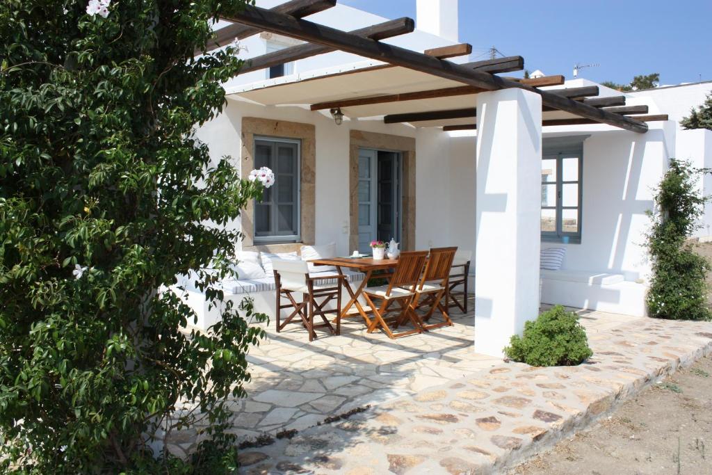 a patio with a table and chairs under a pergola at Patmos Chora Villas 1 &2 in Patmos