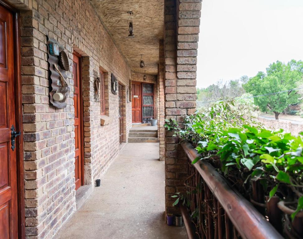 a brick hallway with plants on the side of a building at Bastille de Blignaut B&B in Edenvale
