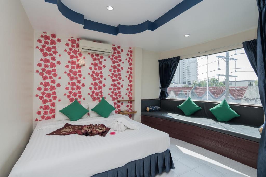 a bedroom with a bed and a window at Heaven House in Patong Beach