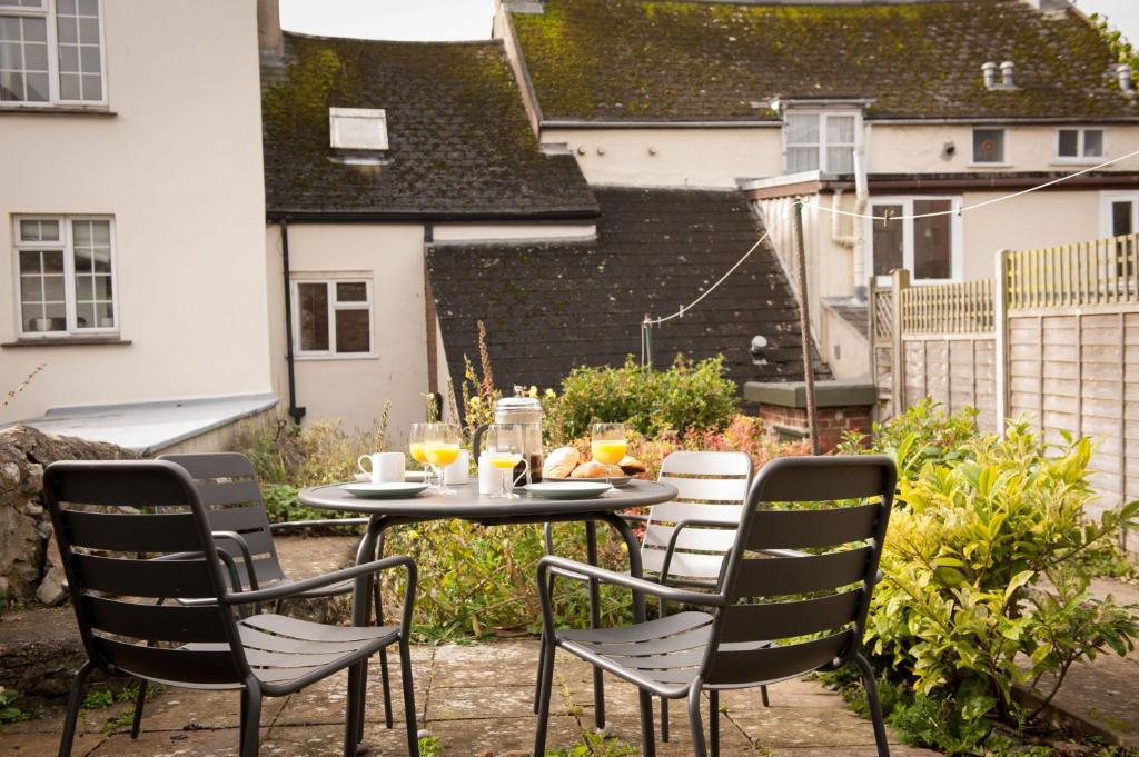 a table and chairs sitting on a patio at Lavender Cottage in Lyme Regis