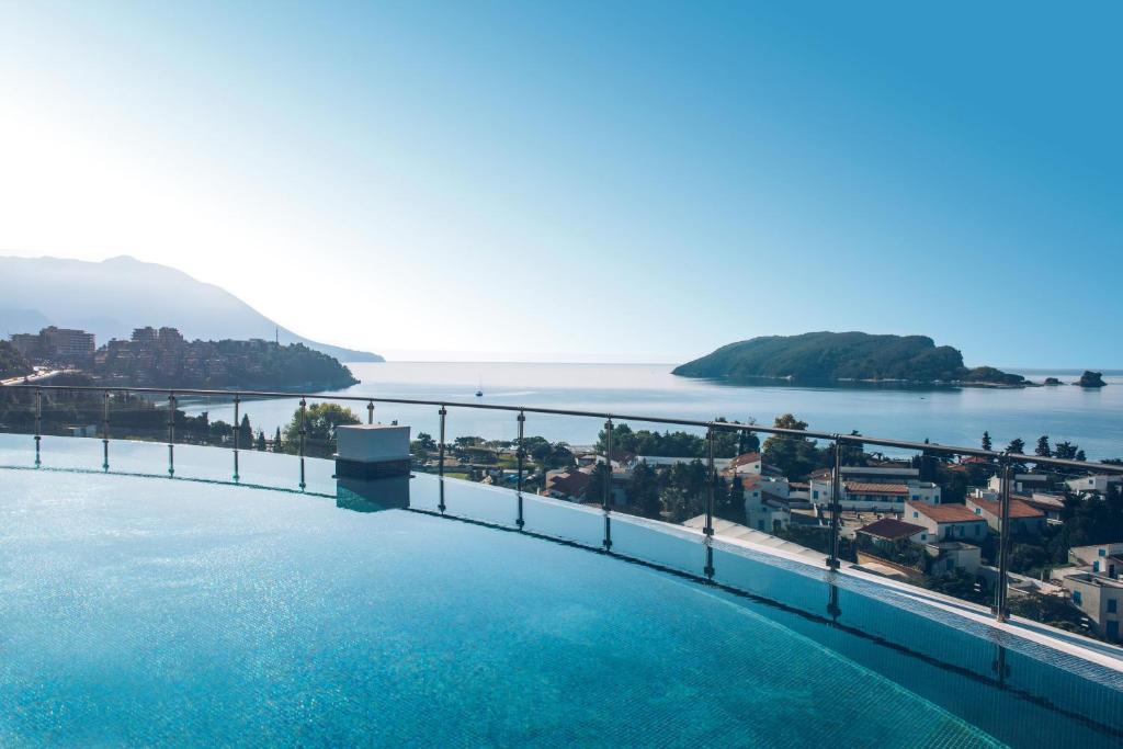 a swimming pool with a view of the water at Iberostar Waves Slavija in Budva
