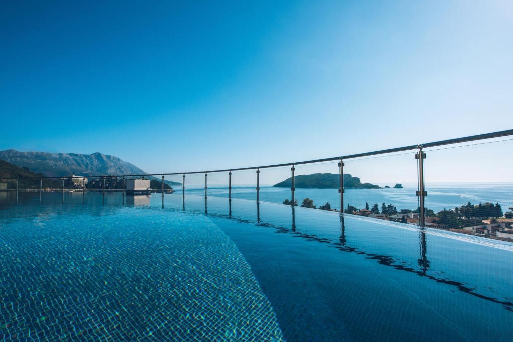 a swimming pool with a view of the water at Iberostar Waves Slavija in Budva