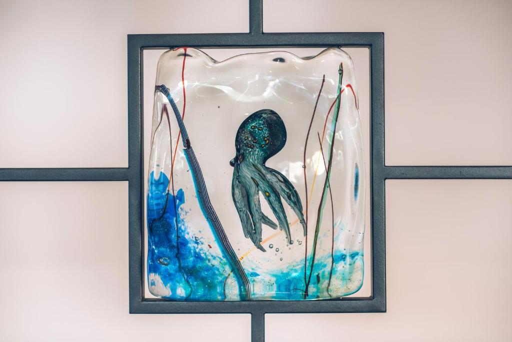 a picture of a mermaid in a glass frame at Iberostar Waves Slavija in Budva
