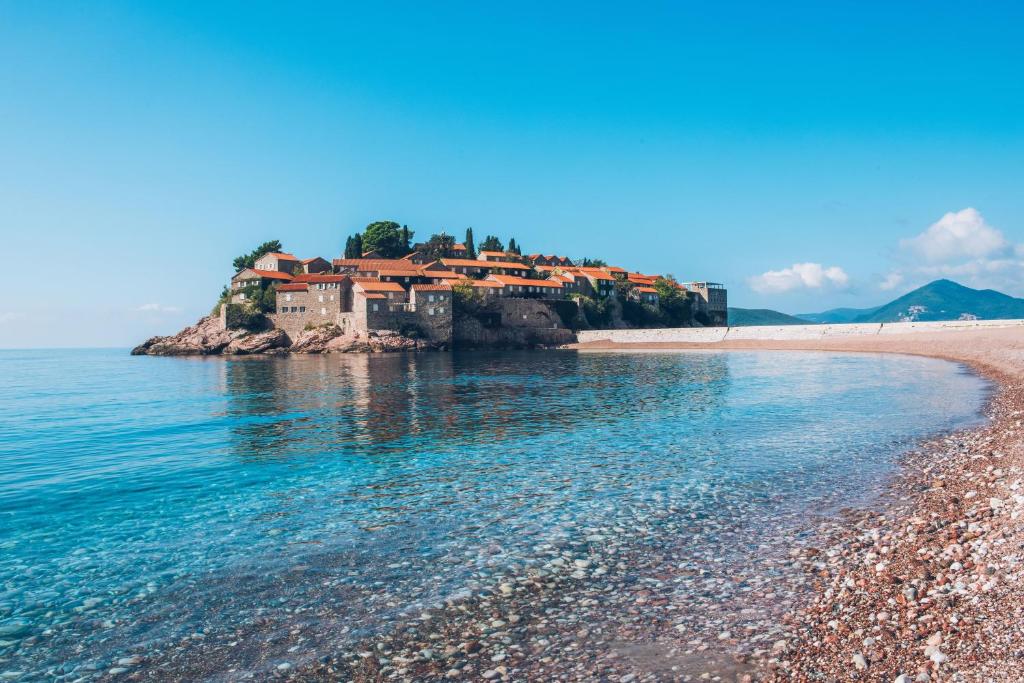 a house on a small island in the water at Iberostar Waves Slavija in Budva