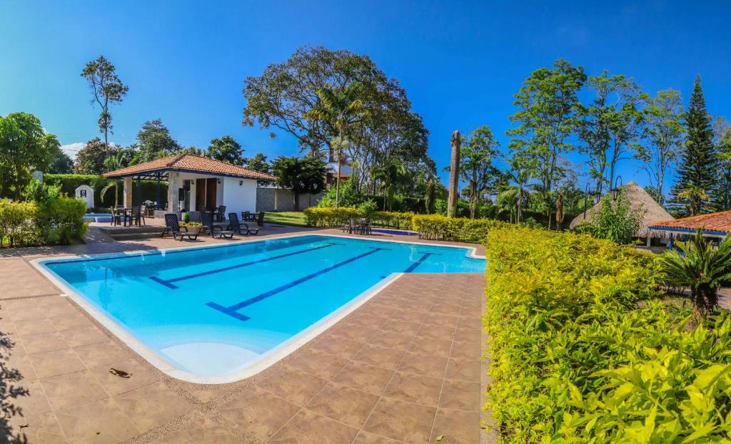 a swimming pool in the backyard of a house at Hotel Campestre Santa Lucia in Montenegro