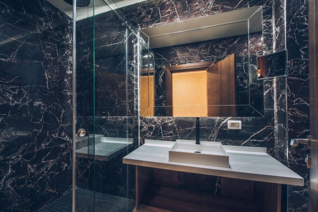 a bathroom with a sink and a mirror at Iberostar Waves Slavija in Budva