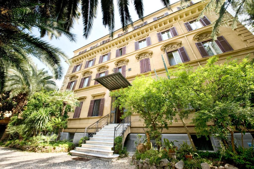 a yellow building with stairs in front of it at Gästehaus Deutscher Orden in Rome